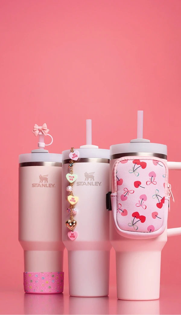 Image of 3 pink Stanley Quencher water bottles with accessories, pink bow straw topper, pink rubber boot, and pink bag. 
Think Pink- Shop Stanley